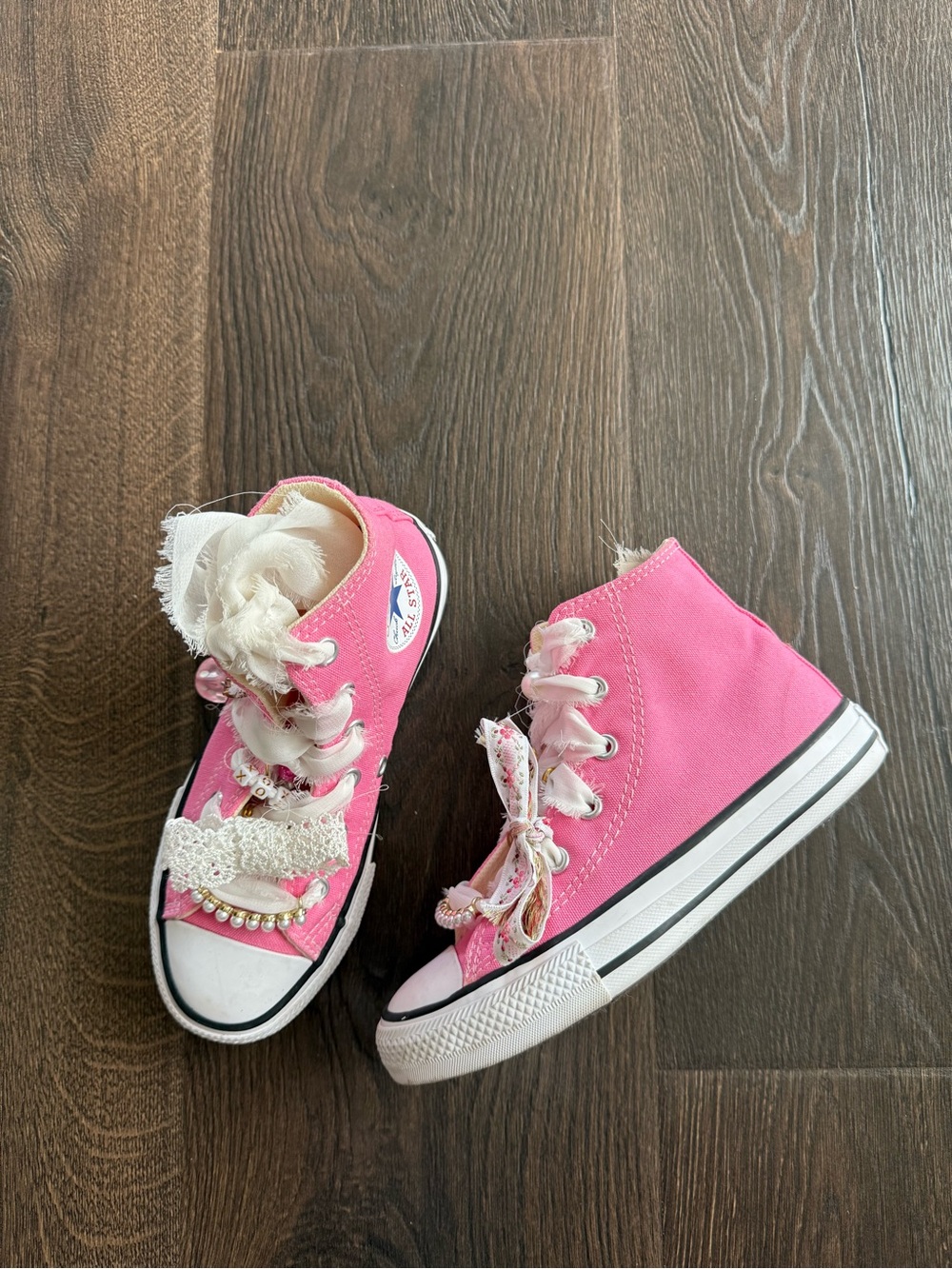 Pink High-Top converse with lace charms